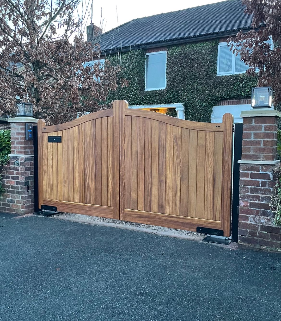 Timber double swing gate with pillar-mounted keypad entry — automated driveway gate