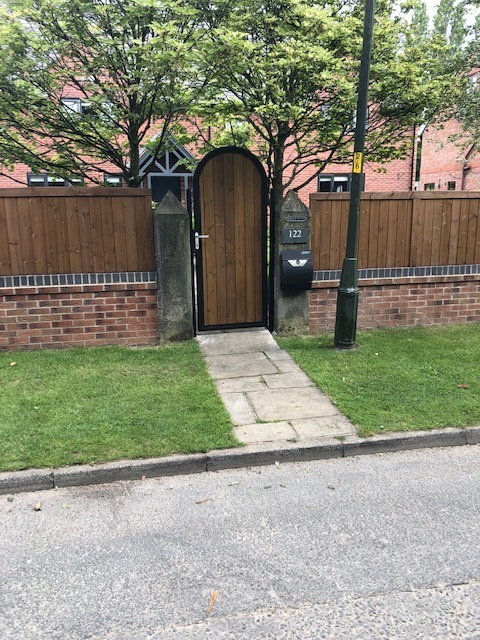 Arched timber pedestrian gate with matching post box