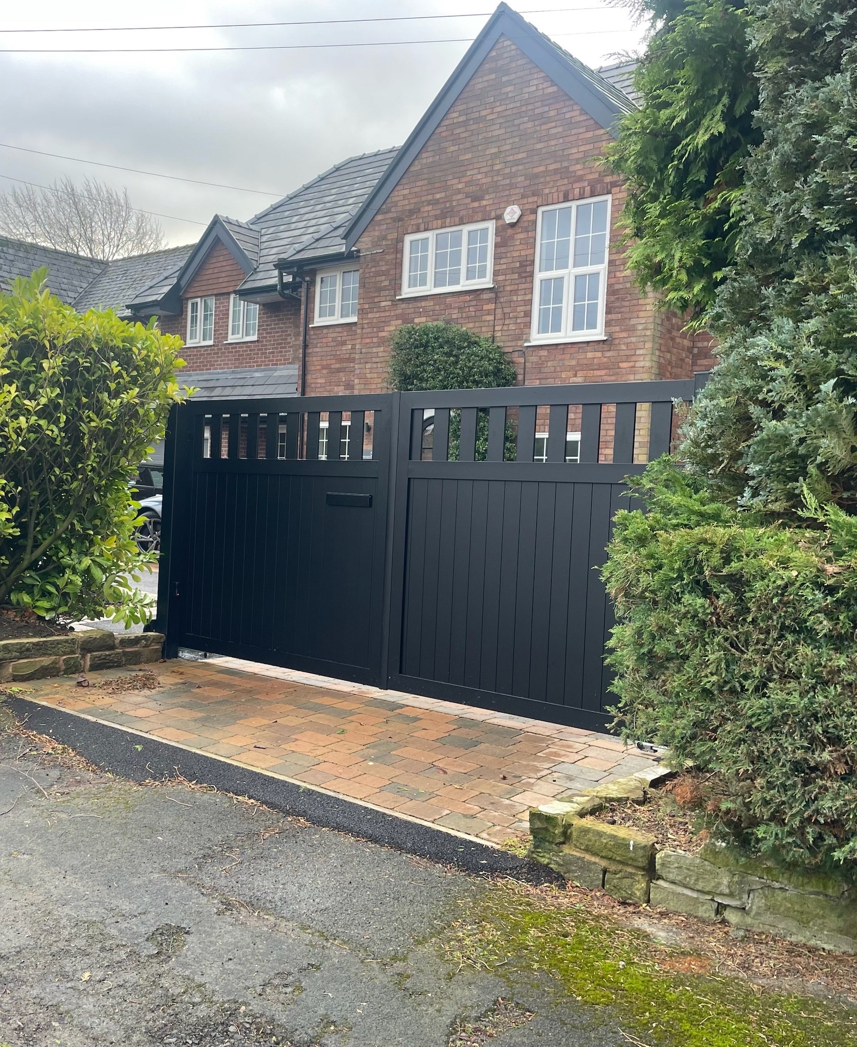 Bespoke black automatic driveway gate installed by MPW Electrical Security